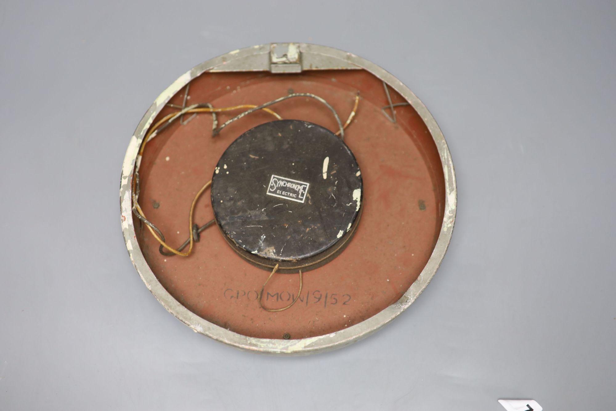 A metal cased circular slave clock, the reverse inscribed GPO